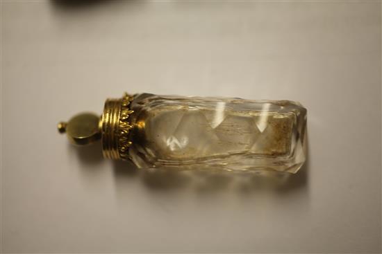 A cased late 18th century gold mounted cut glass miniature scent bottle with stopper and safety chain, approx. 2in.